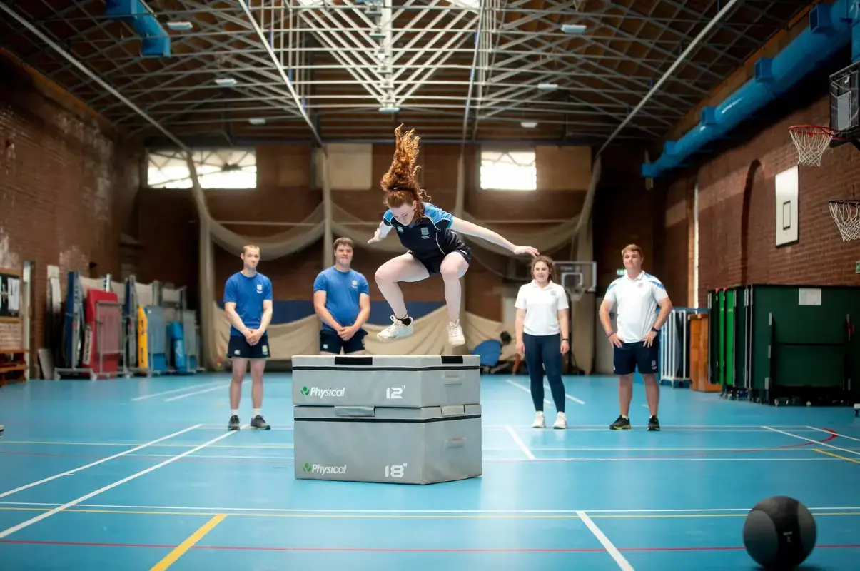 Pocklington School pupil in sports kit jumping onto high sports equipment